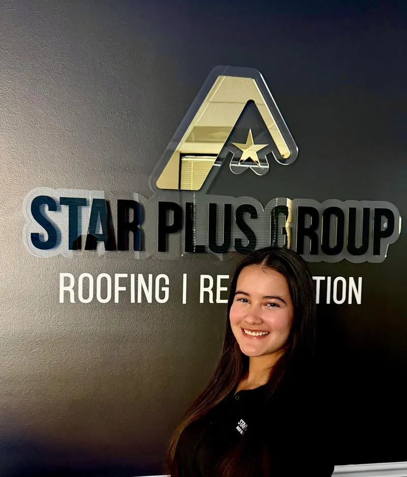 Star Plus Group team member in front of the company sign