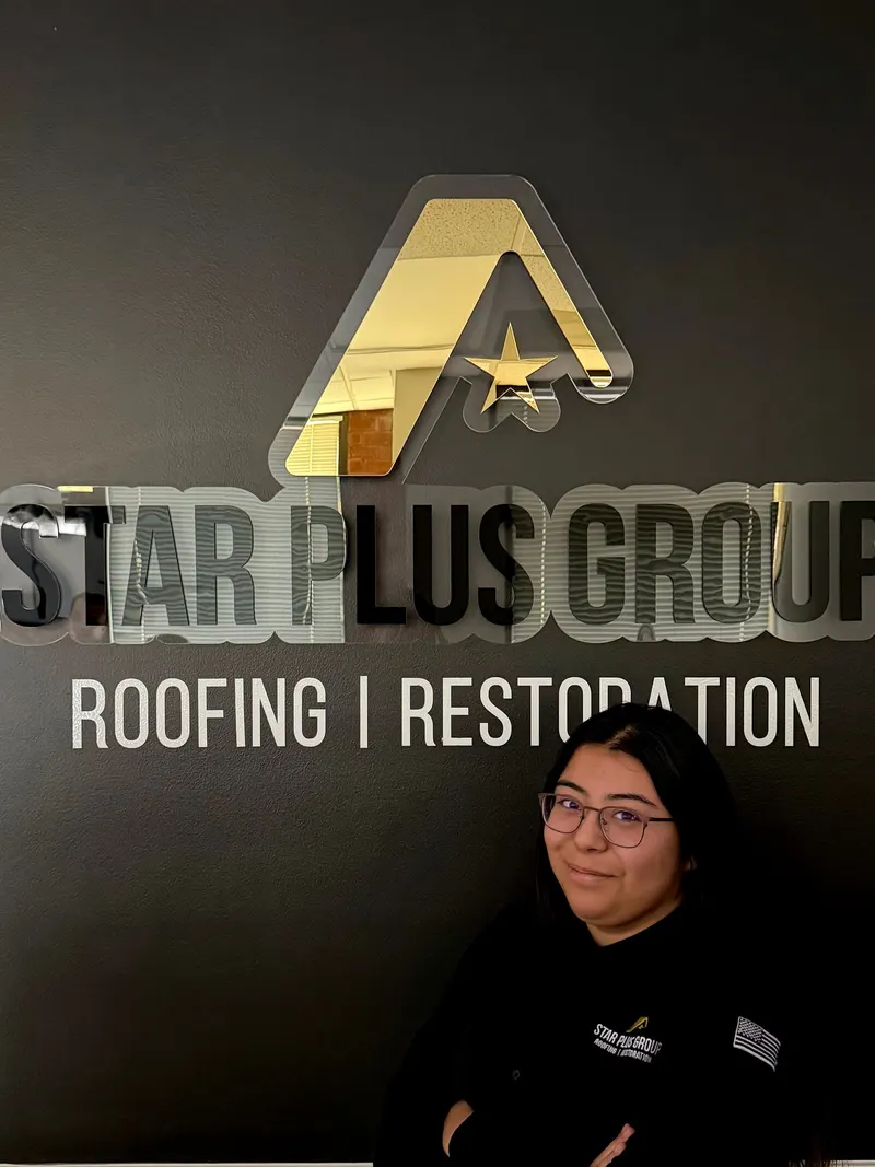 Star Plus Group team member in front of the company sign