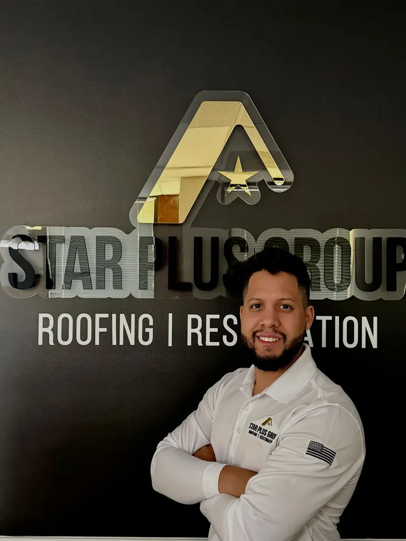 Star Plus Group team member in front of the company sign